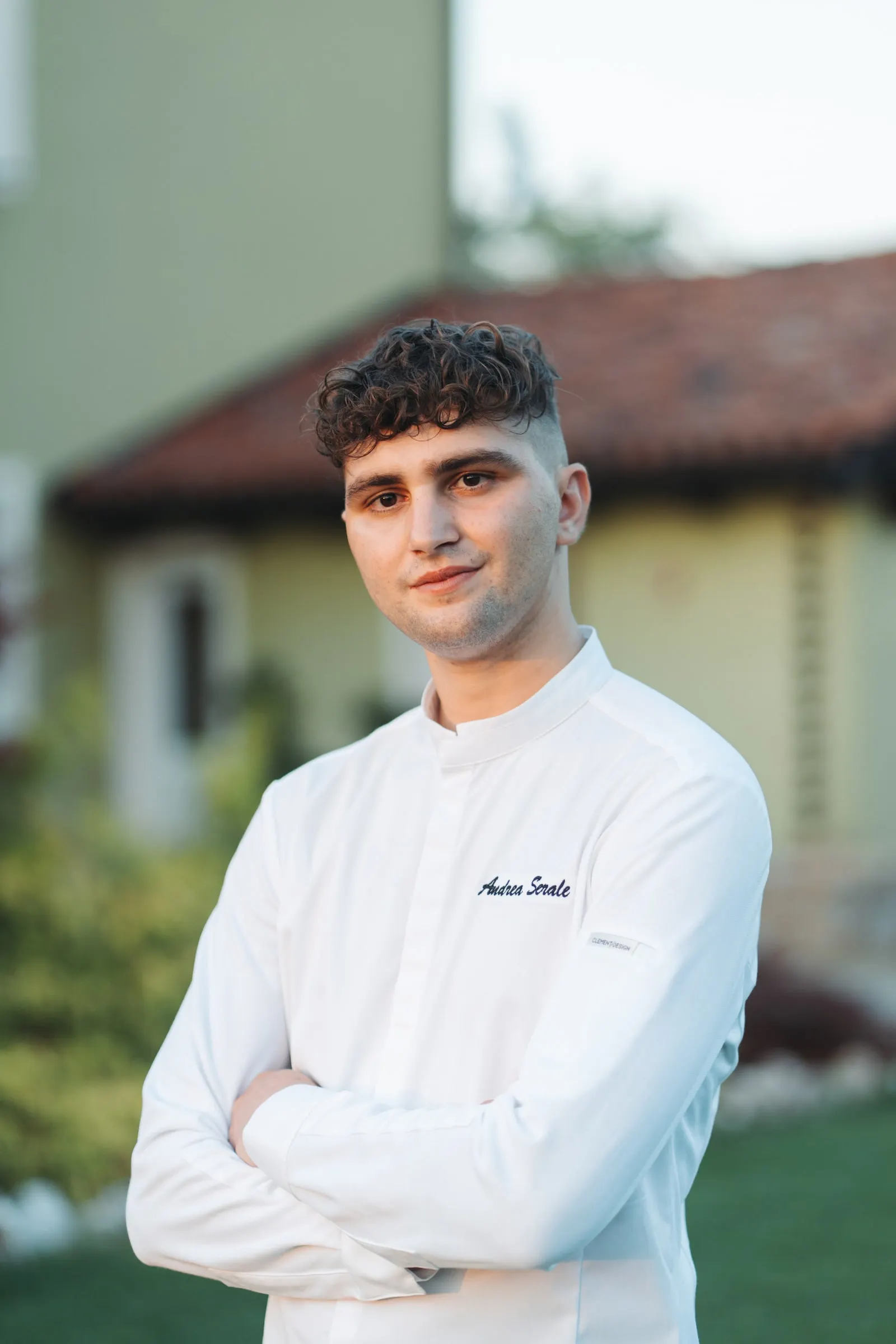 Ritratto di Andrea Serale in giacca da chef davanti a Villa San Lorenzo